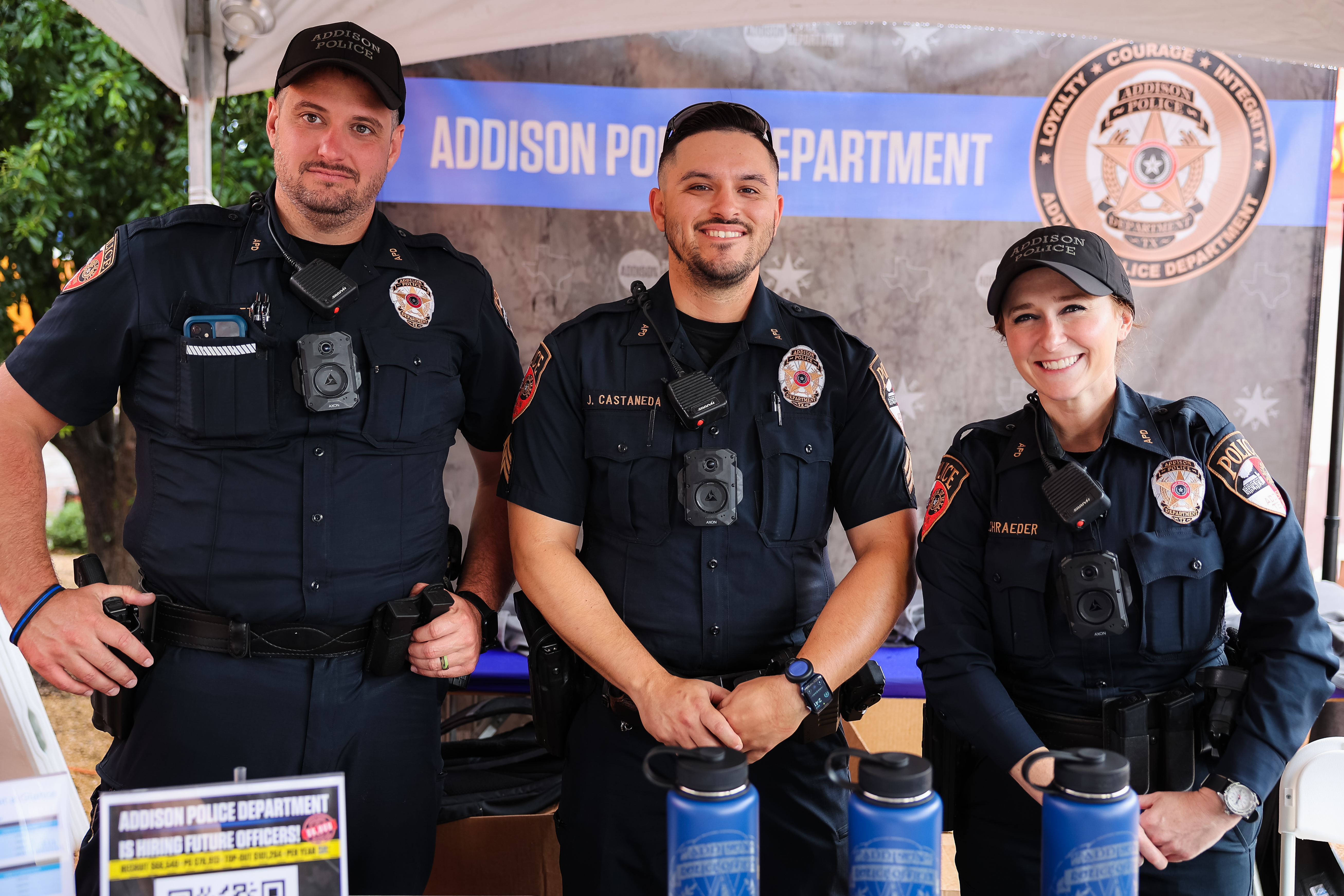 Three Addison Officers standing at an event